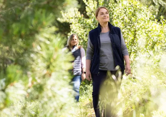 two women walking a nature path